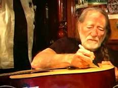 Willie Nelson signs a guitar for a Memorial Day raffle to raise funds for production of several OFFE Public Service Announcements (PSAs) to air nationwide over the next few months